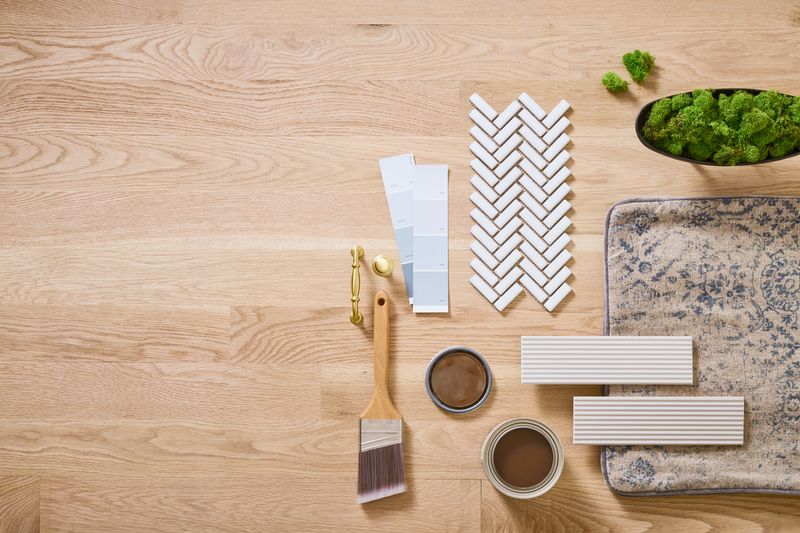 Wood floor with tools, stains, and other items to finish wood flooring