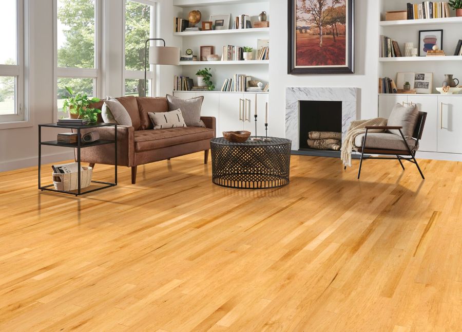 Living room with a fireplace and maple hardwood flooring