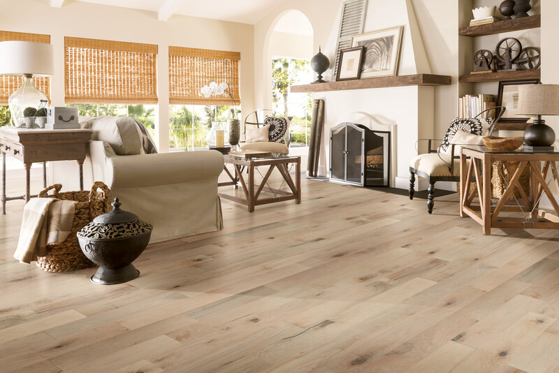 Living room with a fireplace and prefinished maple flooring