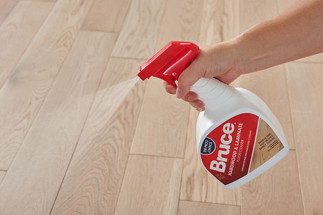 spraying bottle of bruce floor cleaner