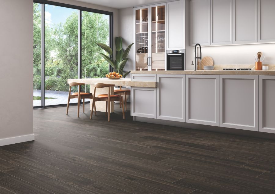 Kitchen setting with an island and waterproof wood grain porcelain flooring
