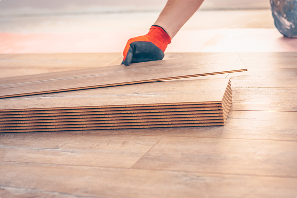 man with gloves acclimating hardwood flooring planks