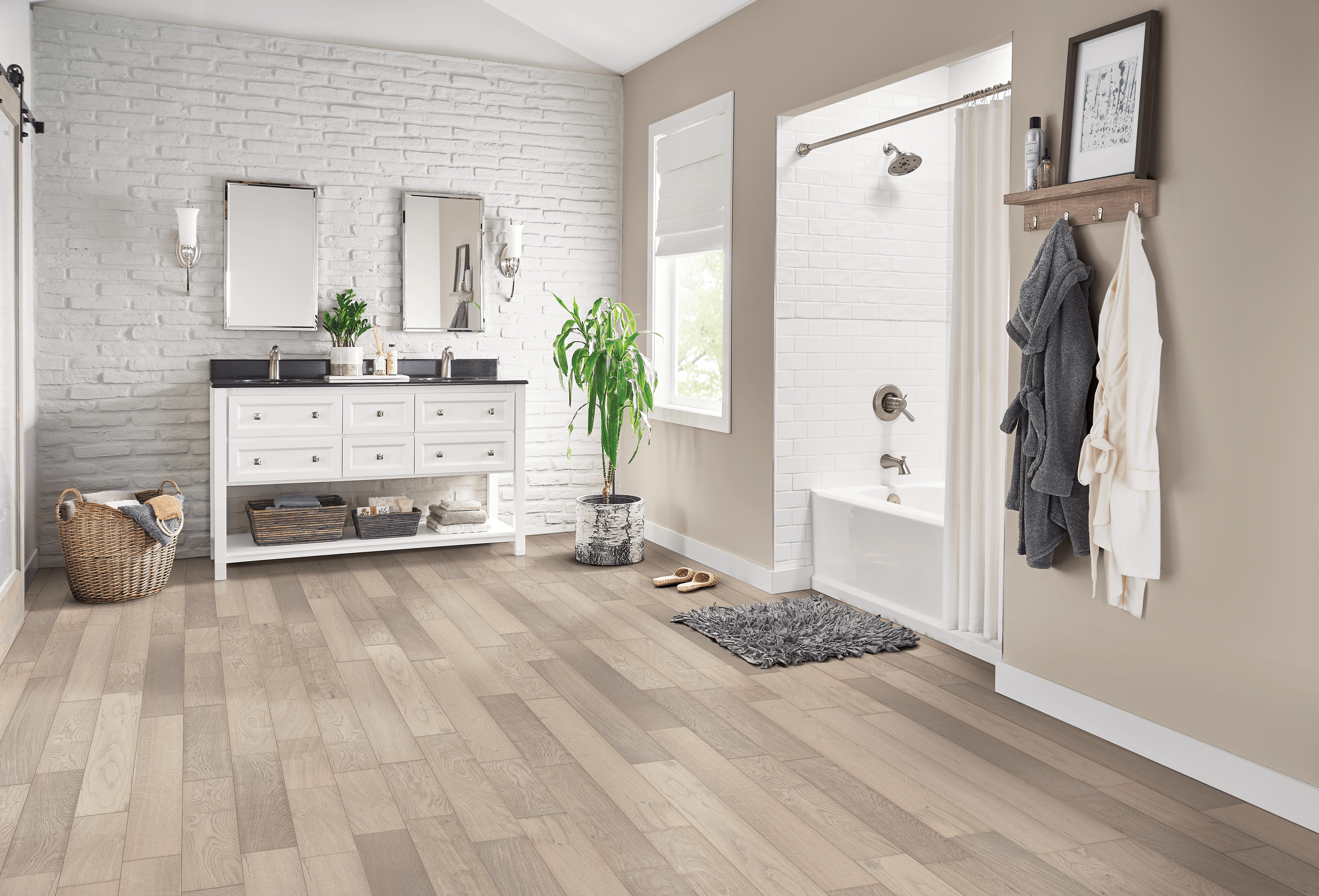 Spacious, light colored bathroom featuring hydropel oak engineered hardwood flooring from Bruce