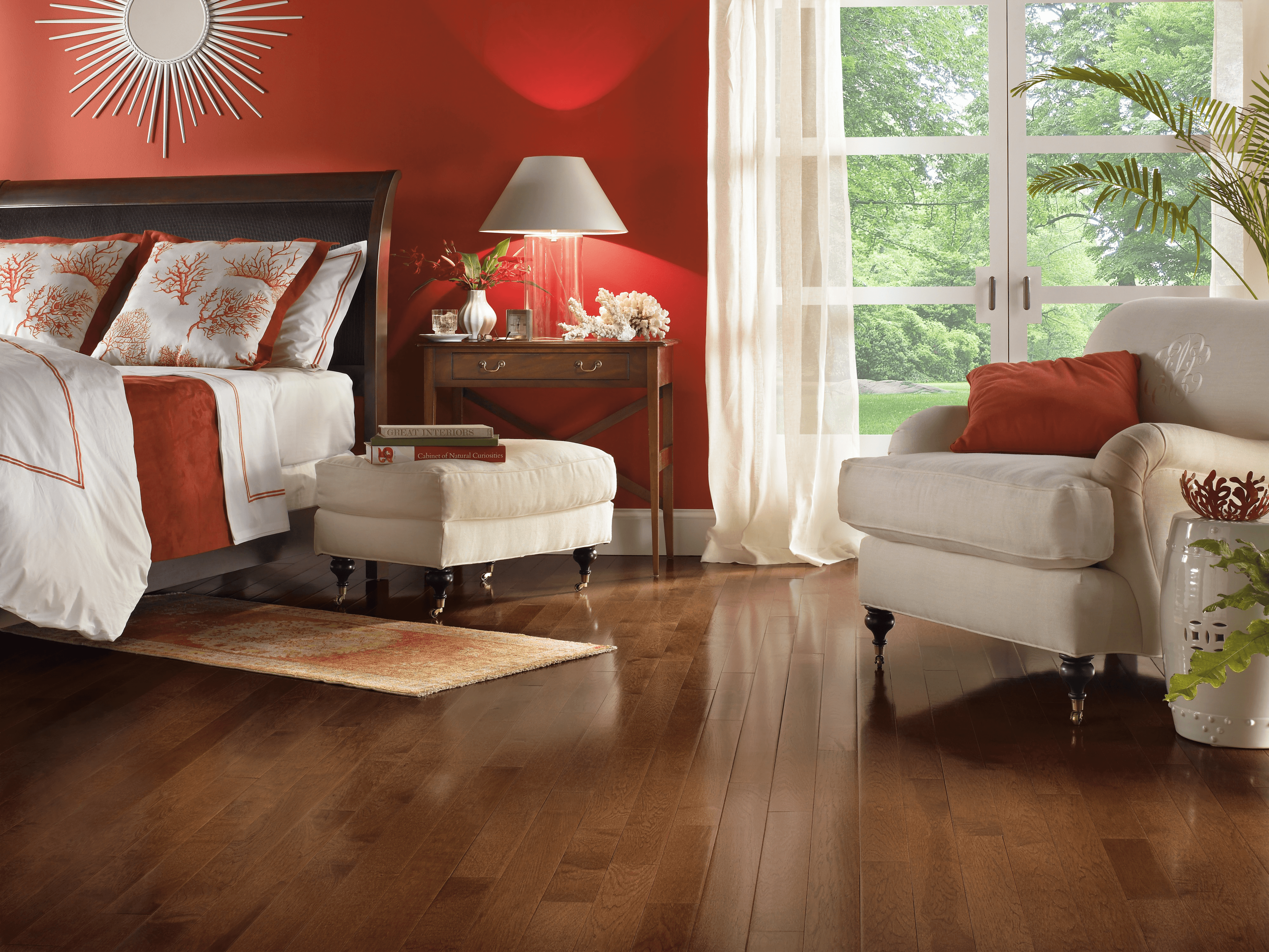 Modern bedroom with a seating area and French doors featuring hickory hardwood floors from Bruce