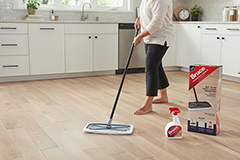 woman cleaning hardwood floor with bruce cleaner